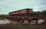 <span class="caption-caption">Tram Motor 26 and trailer cars, crossing Aramac Creek</span>, 1974. <br />Slide, collection of <span class="caption-contributor">Andrew Plunkett</span>.