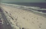 <span class="caption-caption">Tarmac and sand merge, Surfers Paradise</span>, c1960s. <br />Slide, collection of <span class="caption-contributor">Robin Barron</span>.