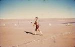 <span class="caption-caption">Captain Phil Darby practising golf on the Birdsville airstrip. Kite hawks stole the balls and Captain Darby had to climb the sand hills to retrieve them, Diamantina Shire</span>, 1972. <br />Slide, collection of <span class="caption-contributor">Dennis Costigan</span>.