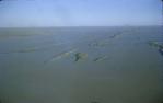 <span class="caption-caption">Sand hills surrounded by flood waters in the Bedourie area, Diamantina Shire</span>, 1972. <br />Slide, collection of <span class="caption-contributor">Dennis Costigan</span>.