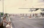<span class="caption-caption">Darwin cyclone refugees boarding an RAAF Hercules at Charleville Airport. Engine replaced at Charleville.</span>, 1975. <br />Slide, collection of <span class="caption-contributor">Dennis Costigan</span>.
