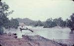 <span class="caption-caption">Constructing new bridge over Cloncurry river, after flood damaged the old bridge. The 'new' bridge has since been replaced by a high level structure, Cloncurry Shire</span>, 1960. <br />Slide, collection of <span class="caption-contributor">Edward Robertson</span>.