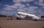 <span class="caption-caption">Airport wih DC3 and passengers, Rockhampton</span>, 1955. <br />Slide, collection of <span class="caption-contributor">Eric Willmott</span>.