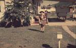 <span class="caption-caption">A carport in Cassia Street, Edge Hill, with a 'bread bin' which fitted onto a ute for bread deliveries. Plus the Brownies' Handbook</span>, 1968. <br />Slide, collection of <span class="caption-contributor">George Laws</span>.