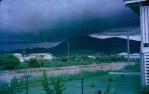 <span class="caption-caption">Caroline Street, Aitkenvale, with a storm over Mount Stuart</span>, 1964. <br />Slide, collection of <span class="caption-contributor">John Donohue</span>.
