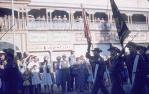 <span class="caption-caption">Anzac Day march in Flinders Street, Townsville, showing the now-demolished town hall building</span>, 1959. <br />Slide, collection of <span class="caption-contributor">John Donohue</span>.