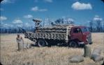 <span class="caption-caption">Loading barley bags, note bag loader, Kingaroy Shire</span>, c1956. <br />Slide, collection of <span class="caption-contributor">John Thun</span>.