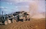 <span class="caption-caption">Thrashing peanuts with stationary thrasher, Kingaroy Shire</span>, c1956. <br />Slide, collection of <span class="caption-contributor">John Thun</span>.