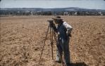 <span class="caption-caption">DPI officer surveying contour bank, Murgon District</span>, 1958. <br />Slide, collection of <span class="caption-contributor">John Thun</span>.