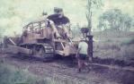 <span class="caption-caption">D7 tractor ploughs into ground to lay telecommunication cable, Banana Shire</span>, 1975. <br />Slide, collection of <span class="caption-contributor">Neville Sim</span>.