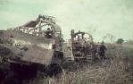 <span class="caption-caption">A 'reinstating' bulldozer fills in the trench as a D7 tractor digs and then lays telecommunication cable, Banana Shire</span>, 1975. <br />Slide, collection of <span class="caption-contributor">Neville Sim</span>.
