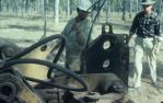 <span class="caption-caption">Feeding telecommunication cable into the combined shute/ground-ripper of the plough, Chinchilla Shire</span>, 1979. <br />Slide, collection of <span class="caption-contributor">Neville Sim</span>.