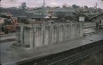 <span class="caption-caption">Air-raid shelter being demolished on Toowong rail platform, beyond is Patterson's sawmill, later a shopping complex, Toowong</span>, 1957. <br />Slide, collection of <span class="caption-contributor">Oswald  Endacott</span>.