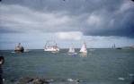 <span class="caption-caption">A swimmer in a shark-proof cage is escorted past Townsville breakwater by the ferry and an RAAF crash launch, as part of the Magnetic Island to Townsville annual swim</span>, 1958. <br />Slide, collection of <span class="caption-contributor">Peter Petersen</span>.