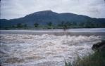 <span class="caption-caption">Looking across the Ross River's Aplins Weir in flood, towards what is now Annandale on the far bank.</span>, 1958. <br />Slide, collection of <span class="caption-contributor">Peter Petersen</span>.
