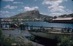 <span class="caption-caption">The South Townsville view of Ross Creek. Long sheds on the city side were Hyne and Son timber wharf, replaced by the Great Barrier Reef Aquarium</span>, 1958. <br />Slide, collection of <span class="caption-contributor">Peter Petersen</span>.