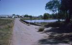 <span class="caption-caption">Wallam Creek causeway, with shopping centre in background, Balonne Shire</span>, 1962. <br />Slide, collection of <span class="caption-contributor">Richard Hopkins</span>.