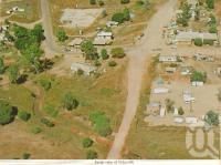 <span class="caption-caption">Aerial view of Rubyvale</span>, 1964. <br />Postcard folder by <span class="caption-publisher">Murray Views Pty Ltd</span>, collection of <span class="caption-contributor">Centre for the Government of Queensland</span>.
