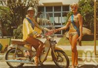 <span class="caption-caption">The Scooter Maid assists forgetful tourists with expired meters. A goodwill service to the public by the Surfers Paradise Progress Association</span>, c1966. <br />Postcard by <span class="caption-publisher">Sydney G. Hughes Pty Ltd</span>, collection of <span class="caption-contributor">Centre for the Government of Queensland</span>.