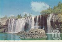 <span class="caption-caption">Millstream Falls near Ravenshoe</span>, c1960. <br />Postcard folder by <span class="caption-publisher">Murray Views Pty Ltd</span>, collection of <span class="caption-contributor">Centre for the Government of Queensland</span>.
