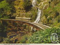 <span class="caption-caption">Stoney Creek Falls and railway bridge, Kuranda</span>, c1964. <br />Postcard folder by <span class="caption-publisher">Murray Views Pty Ltd</span>, collection of <span class="caption-contributor">Centre for the Government of Queensland</span>.