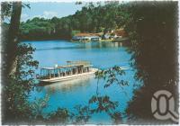 <span class="caption-caption">A glimpse of the lake featuring the cruise boat "MV Lake Barrine Too", Lake Barrine, Atherton Tableland</span>, c1970-2000. <br />Postcard, collection of <span class="caption-contributor">Murray Views Collection</span>.