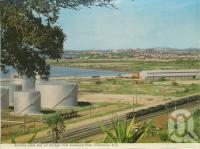 <span class="caption-caption">Alumina Plant and oil storage from Auckland Park, Gladstone</span>, c1975. <br />Postcard folder by <span class="caption-publisher">Murray Views Pty Ltd</span>, collection of <span class="caption-contributor">Centre for the Government of Queensland</span>.