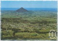<span class="caption-caption">Aerial view of Cooroy with Cooroy Mountain and the coastline to the east</span>, c1970-2000. <br />Postcard, collection of <span class="caption-contributor">Murray Views Collection</span>.